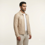 Side view of a man wearing a beige zip jacket with white t-shirt