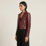 Close-up of burgundy biker jacket lapel with gold snap button and zipper